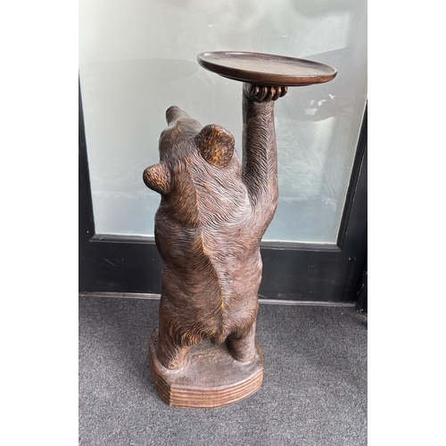 651 - A large Black Forest figure of a bear, with later oak dish top, 71cm high