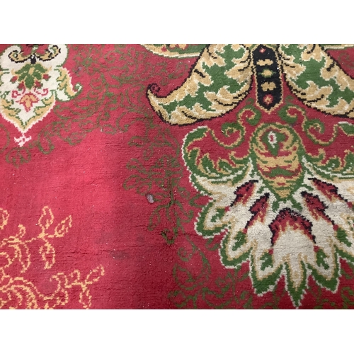 87 - An Indian style machined red ground carpet, approx. 440 x 290cm