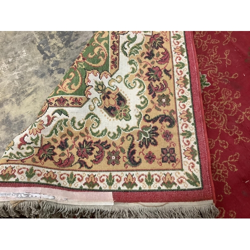 87 - An Indian style machined red ground carpet, approx. 440 x 290cm