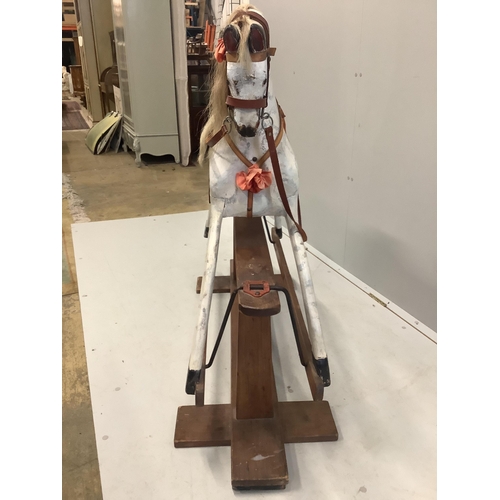 1042 - An early 20th century dapple grey rocking horse on pine safety frame, length 130cm, height 106cm... 