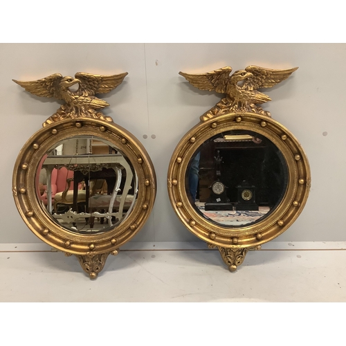 1066 - A pair of Regency style circular gilt framed wall mirrors, width 46cm, height 69cm