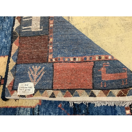 1122 - A Gabbeh blue ground carpet, 180cm x 148cm