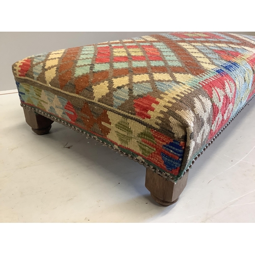 1164 - A rectangular Kilim footstool, on oak feet width 111cm, depth 60cm, height 25cm