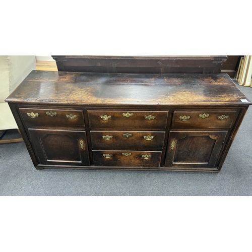 1166 - A mid 18th century oak low dresser, fitted five drawers, flanked by panelled doors, width 174cm, dep... 