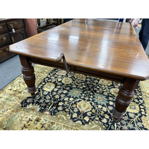 1169 - A late Victorian walnut extending dining table, on turned fluted baluster legs, 240cm extended,  two... 