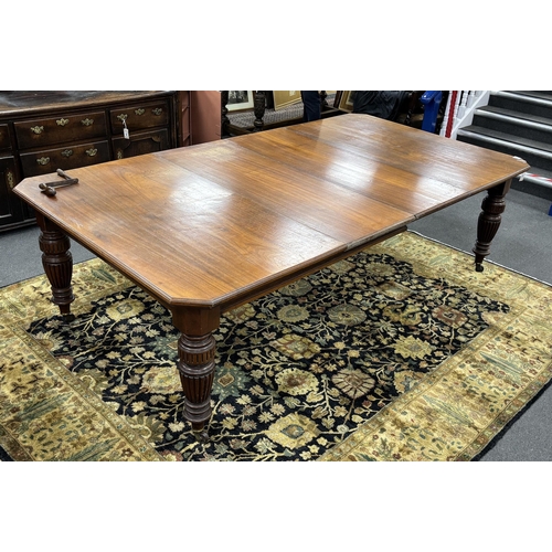 1169 - A late Victorian walnut extending dining table, on turned fluted baluster legs, 240cm extended,  two... 