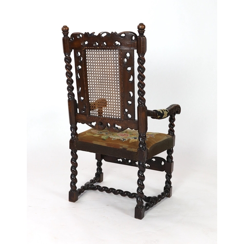 1175 - * * A Charles II carved walnut caned back elbow chair, with a contemporary needlework upholstered se... 