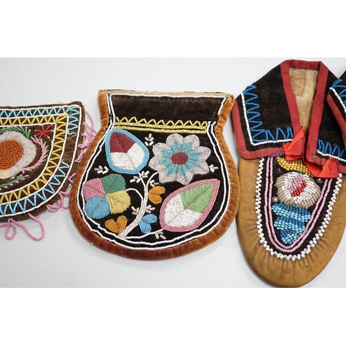 1328 - A pair of mid to late 19th century North American Indian moccasins, worked in floral beadwork on vam... 