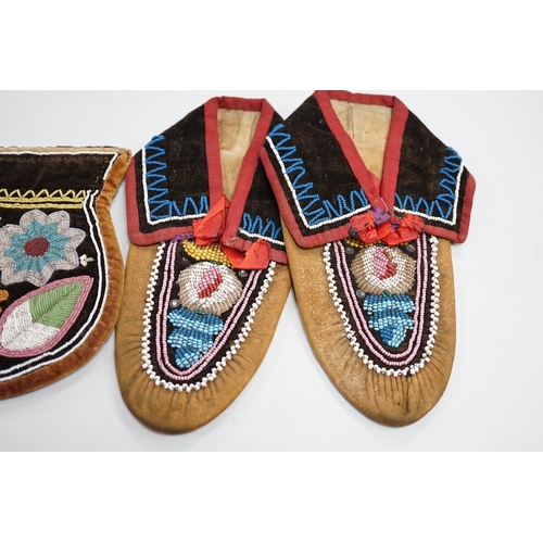 1328 - A pair of mid to late 19th century North American Indian moccasins, worked in floral beadwork on vam... 