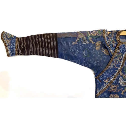 1340 - A Chinese fine blue gauze summer robe embroidered with a gold thread dragon highlighted by coloured ... 