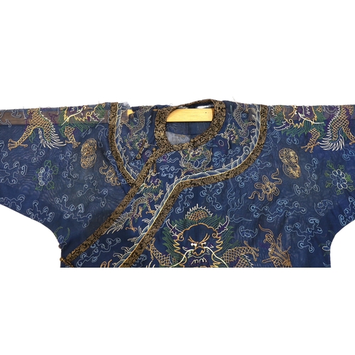 1340 - A Chinese fine blue gauze summer robe embroidered with a gold thread dragon highlighted by coloured ... 