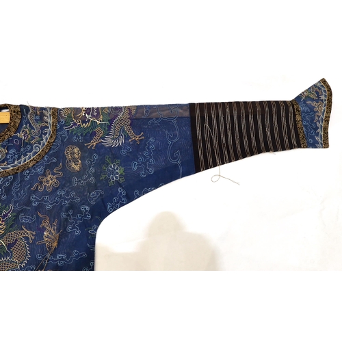 1340 - A Chinese fine blue gauze summer robe embroidered with a gold thread dragon highlighted by coloured ... 