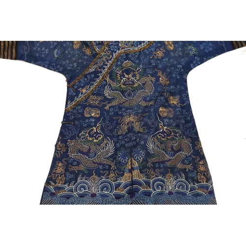 1340 - A Chinese fine blue gauze summer robe embroidered with a gold thread dragon highlighted by coloured ... 