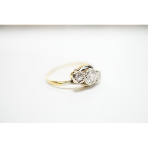 2000 - A yellow metal and illusion set three stone diamond set crossover ring, size O/P, gross weight 3.2 g... 