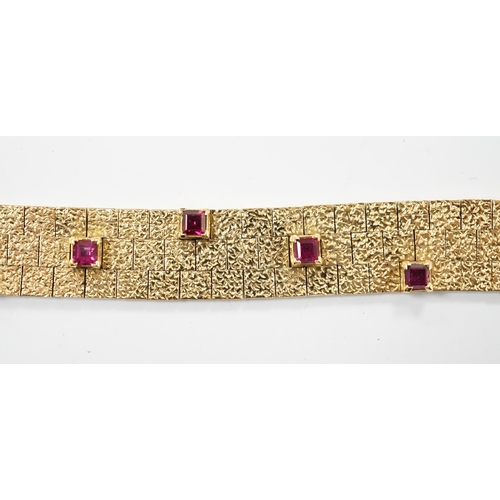 2003 - A textured yellow metal and eleven stone square cut  ruby set bracelet, 16.5cm, gross weight 36.8 gr... 