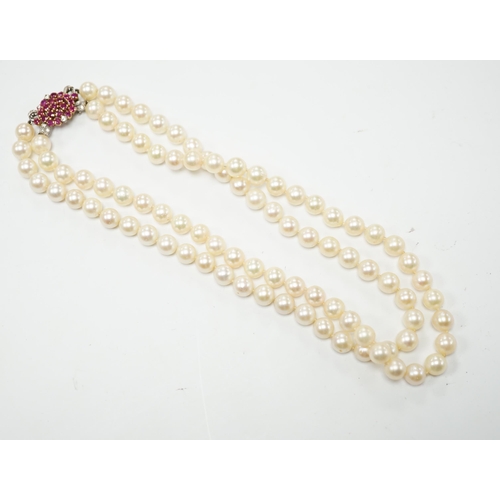 2005 - A double strand cultured pearl choker necklace with yellow and white metal, ruby and diamond cluster... 