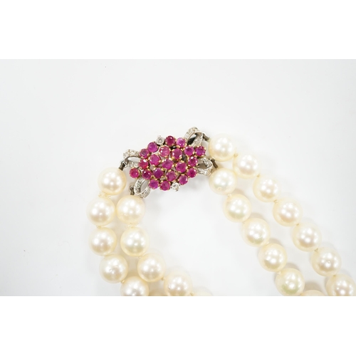 2005 - A double strand cultured pearl choker necklace with yellow and white metal, ruby and diamond cluster... 