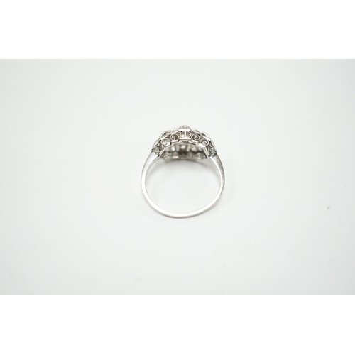 2010 - An Art Deco style white metal and millegrain set diamond cluster ring, size N/O, gross weight 4.1 gr... 