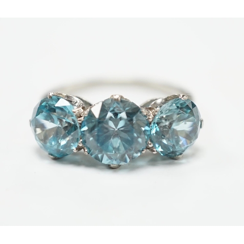 2011 - A white metal and three stone blue zircon set dress ring, size L, gross weight 4.1 grams.