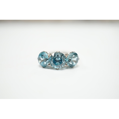 2011 - A white metal and three stone blue zircon set dress ring, size L, gross weight 4.1 grams.