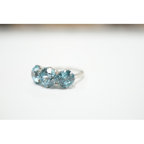 2011 - A white metal and three stone blue zircon set dress ring, size L, gross weight 4.1 grams.