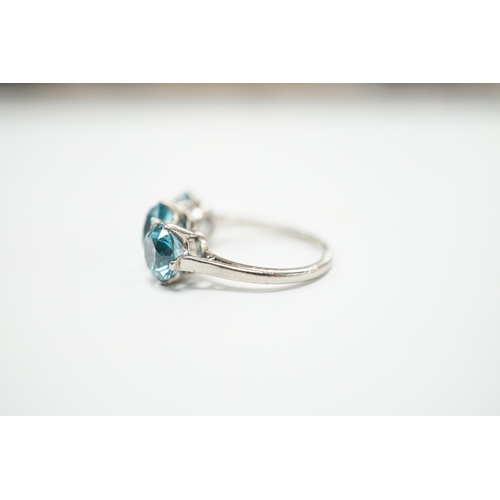 2011 - A white metal and three stone blue zircon set dress ring, size L, gross weight 4.1 grams.