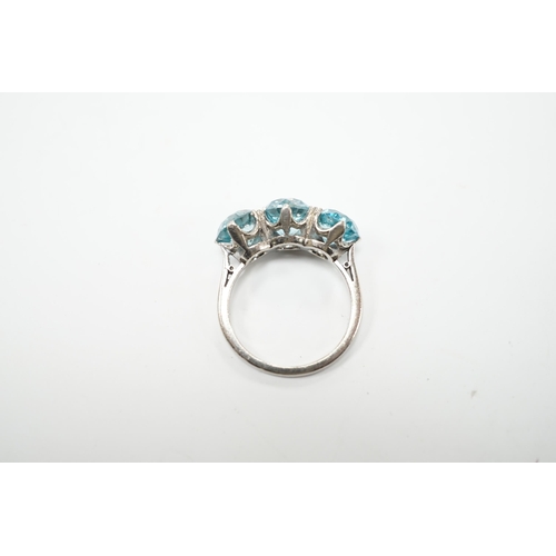 2011 - A white metal and three stone blue zircon set dress ring, size L, gross weight 4.1 grams.