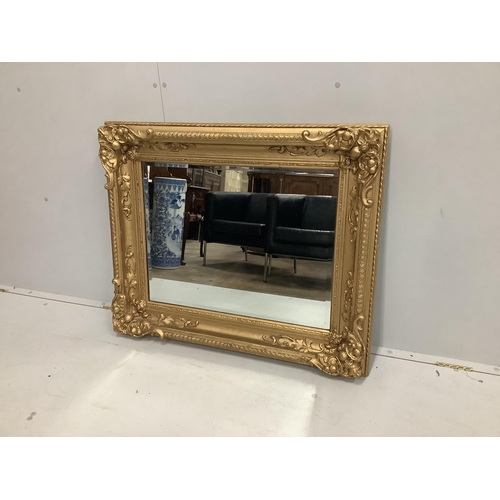 21 - A Victorian style rectangular giltwood composition wall mirror (converted picture frame), width 97cm... 