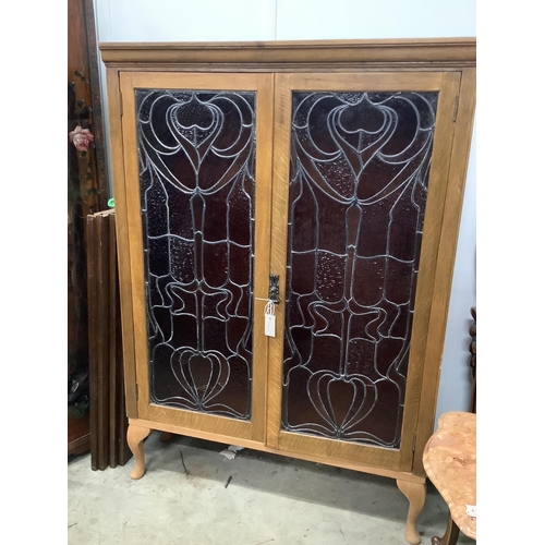 24 - A pair of Art Nouveau stained glass panels, now as an oak bookcase, width 104cm, depth 29cm, height ... 