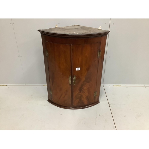 38 - A George III mahogany bow front hanging corner cupboard, width 69cm, depth 48cm, height 90cm