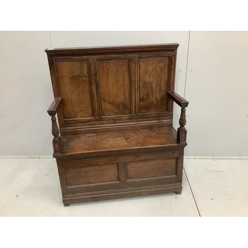 44 - A small panelled oak box settle, width 96cm, depth 34cm, height 114cm