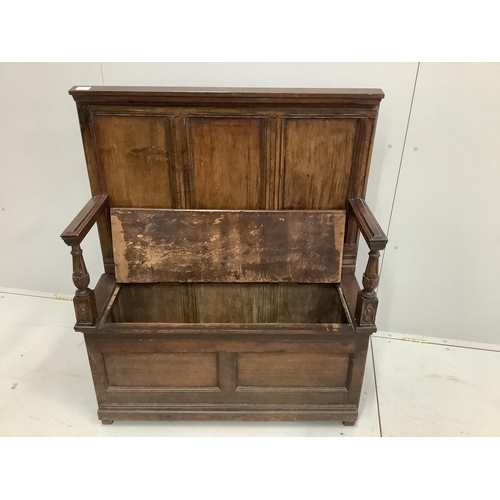 44 - A small panelled oak box settle, width 96cm, depth 34cm, height 114cm