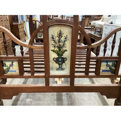 45 - A 19th century Zanzibar hardwood bedframe inset reverse painted glass panels of peacocks and vases o... 