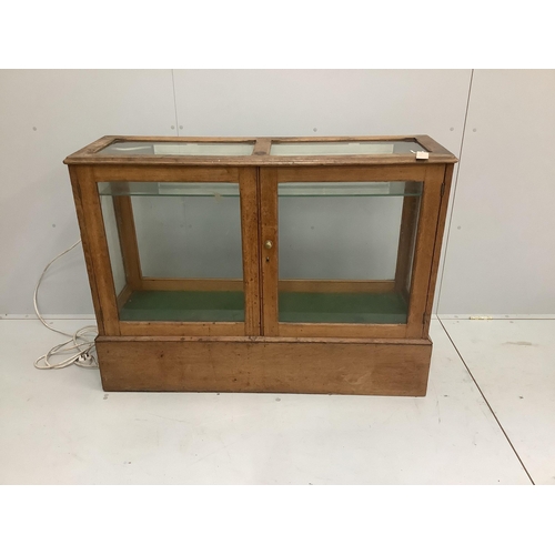 65 - An early 20th century glazed oak shop display cabinet, width 124cm, depth 40cm, height 91cm