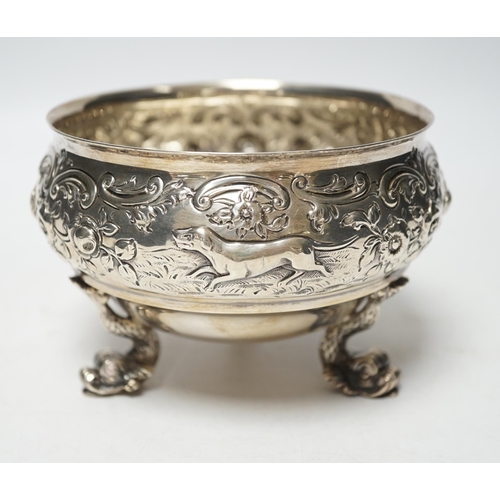 845 - An Edwardian embossed silver bowl, on three dolphin supports, Wakely & Wheeler, London, 1905, diamet... 