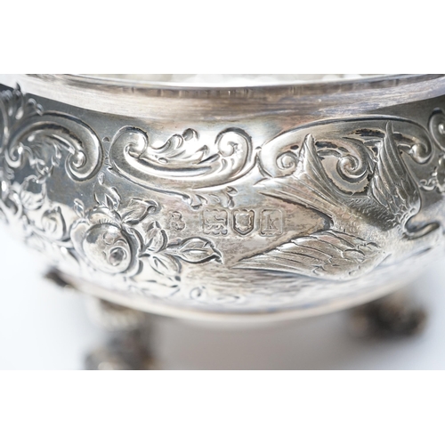 845 - An Edwardian embossed silver bowl, on three dolphin supports, Wakely & Wheeler, London, 1905, diamet... 