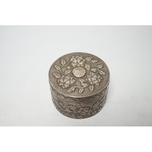 853 - An early 20th century Chinese white metal circular box and cover, maker's mark MK, with foliate deco... 