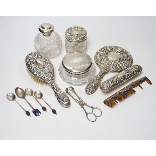 857 - Seven assorted silver mounted glass scent bottles or toilet jars, and a repousse silver backed four ... 