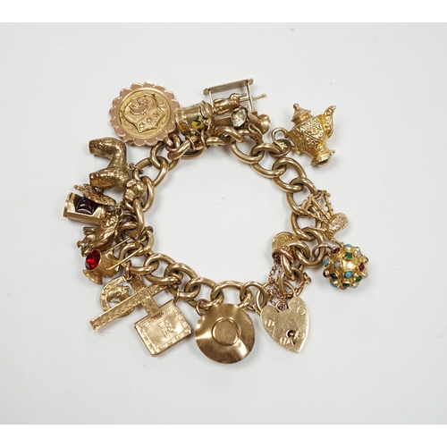 902 - An early 1960's 9ct gold curb link charm bracelet, hung with fifteen assorted charms, including twel... 