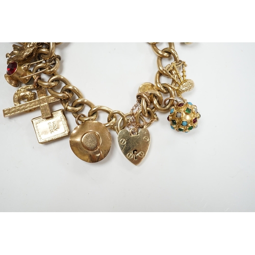 902 - An early 1960's 9ct gold curb link charm bracelet, hung with fifteen assorted charms, including twel... 