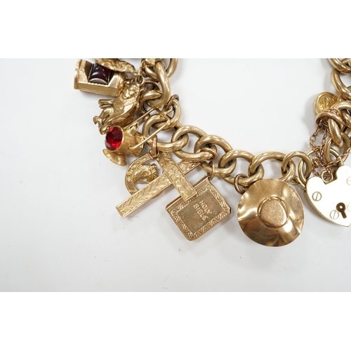 902 - An early 1960's 9ct gold curb link charm bracelet, hung with fifteen assorted charms, including twel... 