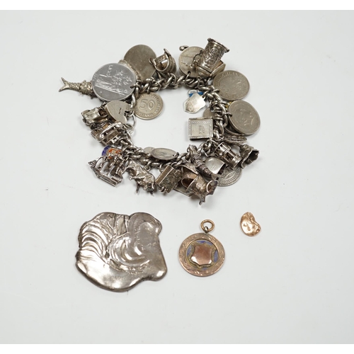 906 - A silver charm bracelet, hung with assorted mainly white metal charms including tankard and Knight's... 