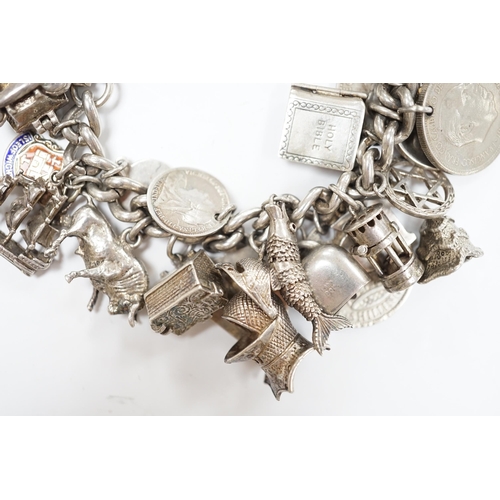 906 - A silver charm bracelet, hung with assorted mainly white metal charms including tankard and Knight's... 