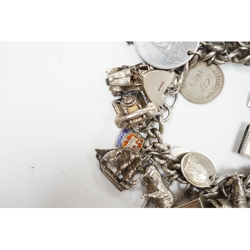 906 - A silver charm bracelet, hung with assorted mainly white metal charms including tankard and Knight's... 