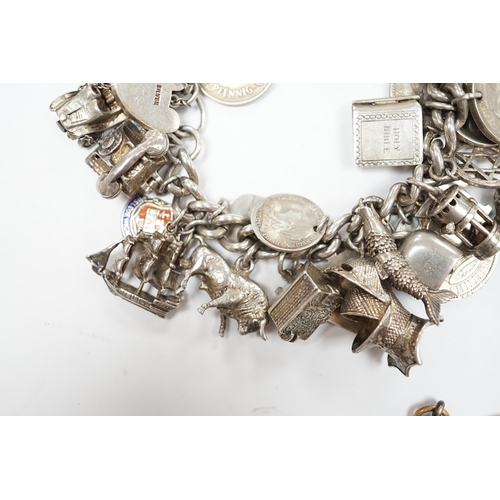 906 - A silver charm bracelet, hung with assorted mainly white metal charms including tankard and Knight's... 