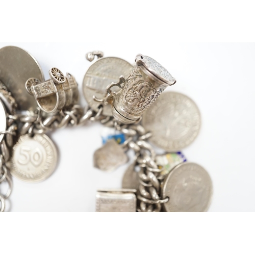 906 - A silver charm bracelet, hung with assorted mainly white metal charms including tankard and Knight's... 