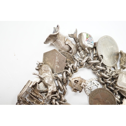 906 - A silver charm bracelet, hung with assorted mainly white metal charms including tankard and Knight's... 