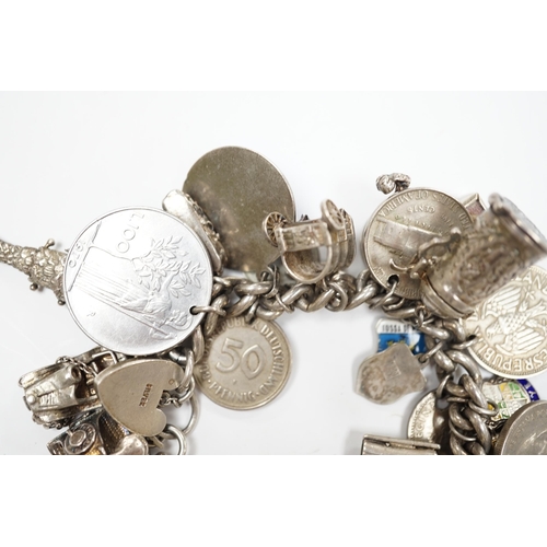 906 - A silver charm bracelet, hung with assorted mainly white metal charms including tankard and Knight's... 