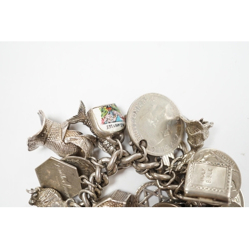 906 - A silver charm bracelet, hung with assorted mainly white metal charms including tankard and Knight's... 