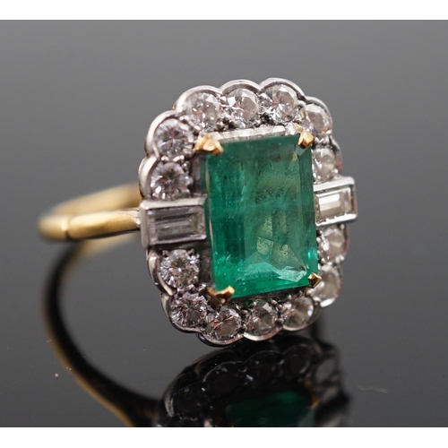 909 - An Art Deco style gold, emerald and diamond set oval cluster ring, the central emerald measuring app... 